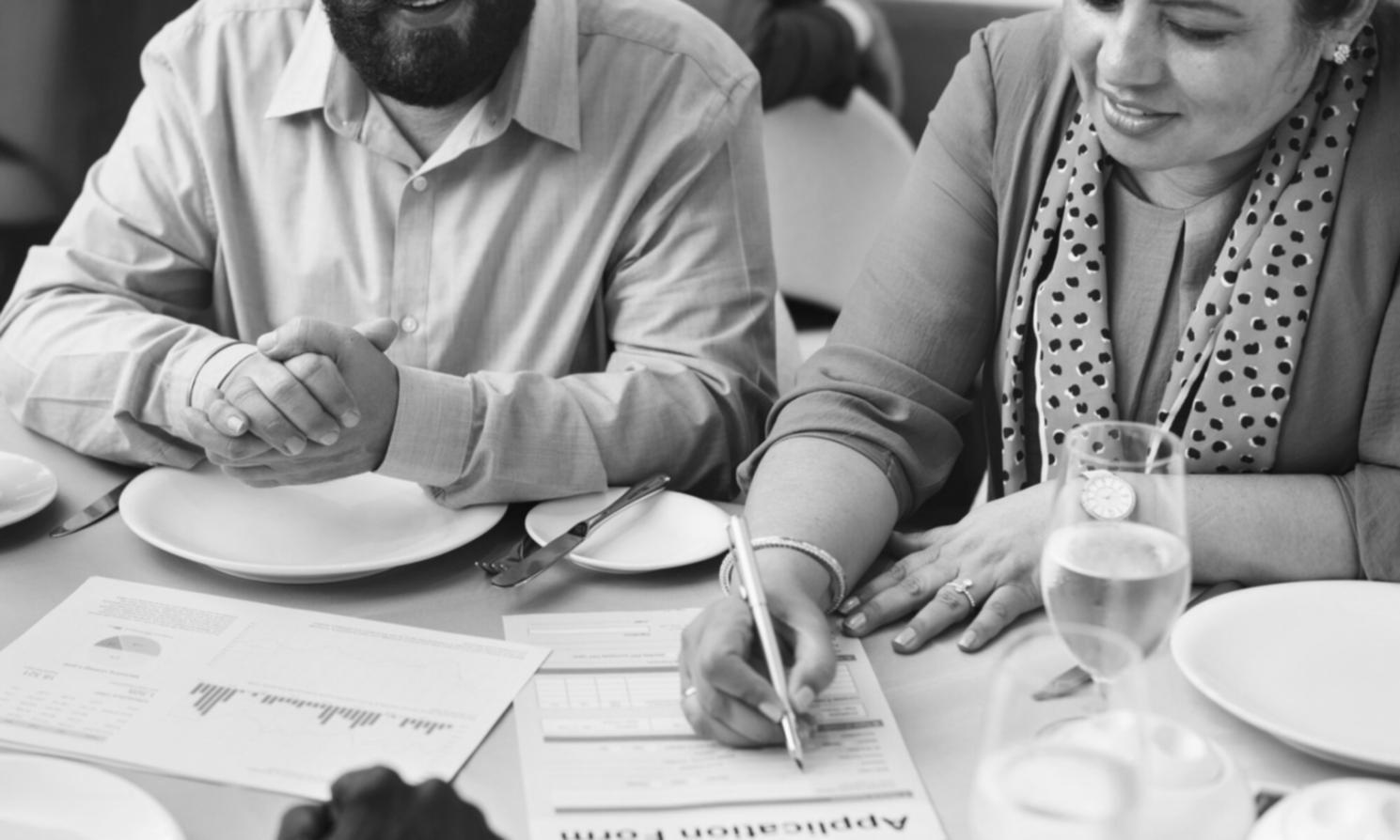 Students reviewing financial charts and investment materials during workshop session